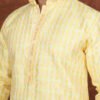 Men wearing pastel heritage jacquard kurta in vibrant yellow with embroidered neckline for wedding and festive wear