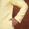 Men wearing pastel heritage jacquard kurta in vibrant yellow with embroidered neckline for wedding and festive wear