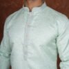 Men wearing aarav pastel green jacquard kurta with mandarin collar for wedding and festive wear