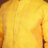 Men wearing suryakant jacquard kurta in vibrant yellow with mandarin collar for wedding and festive wear